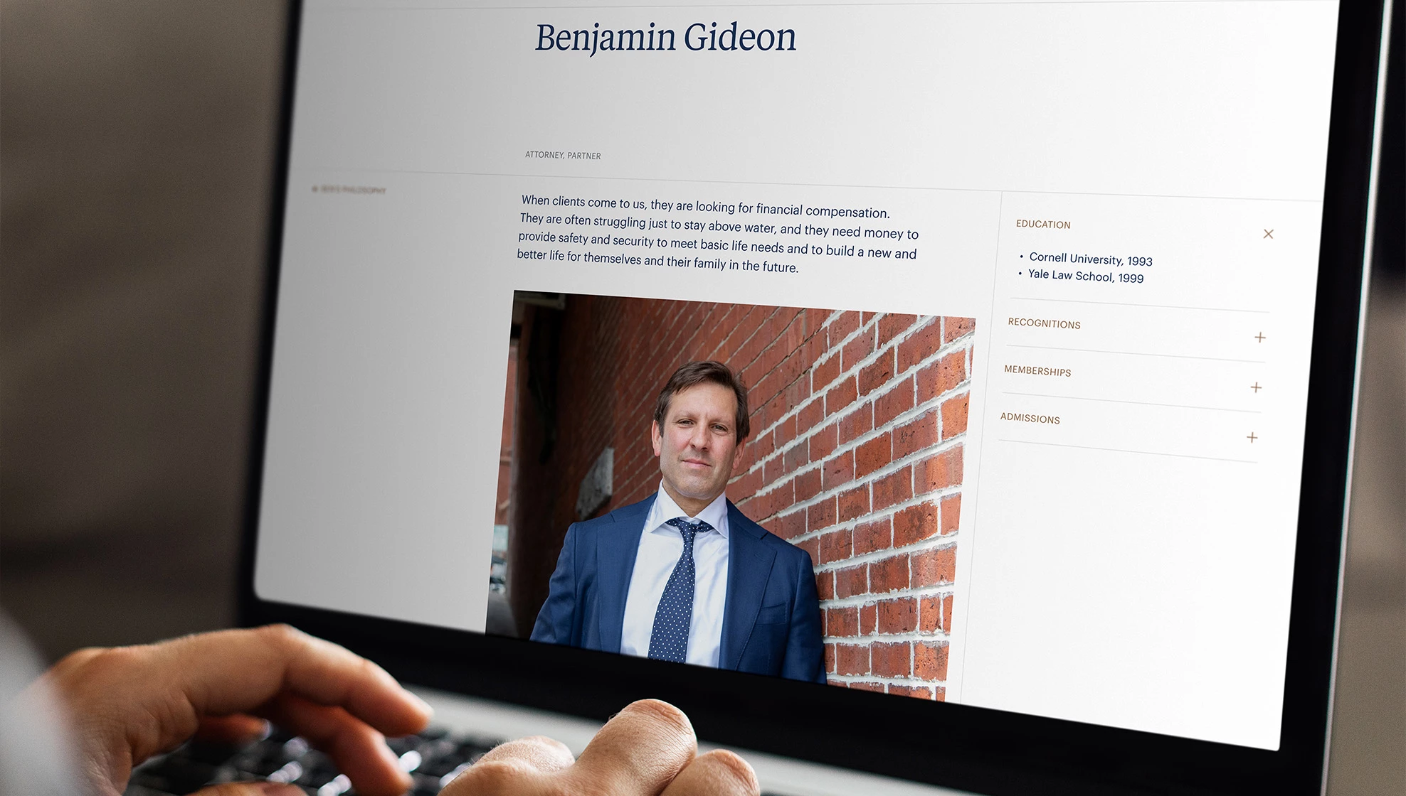 Gideon Asen attorney biography page for partner Benjamin Gideon displayed on a laptop, showing his photo, philosophy statement, and education credentials