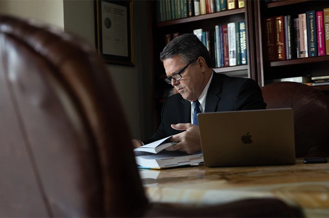 Mark Clore working in conference room