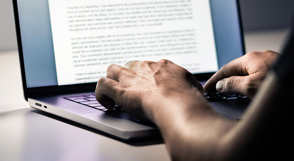 Person writing law firm SEO content on a laptop to support a legal link building campaign