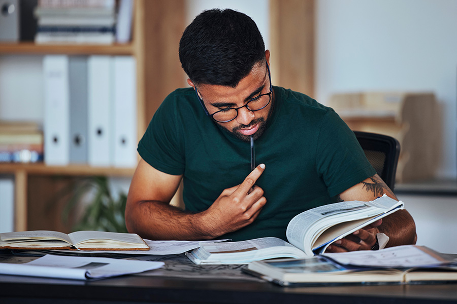 Marketing professional researching law firm link building strategies with open books and notes